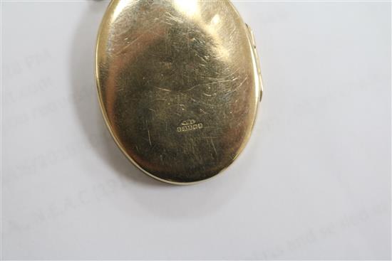 An engraved 9ct gold oval locket on a 9ct chain, locket 4cm.